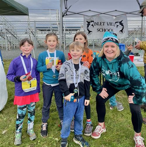 Kids with PE teacher at running race